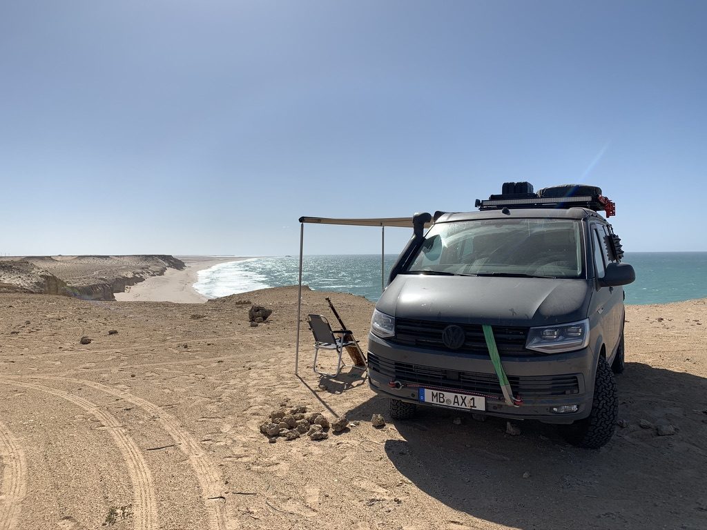 Expedition van camped on an empty Atlantic beach