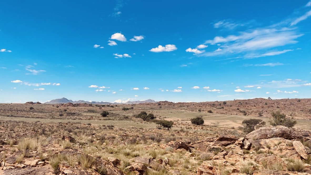 Wide stony plain reaching towards distant hills