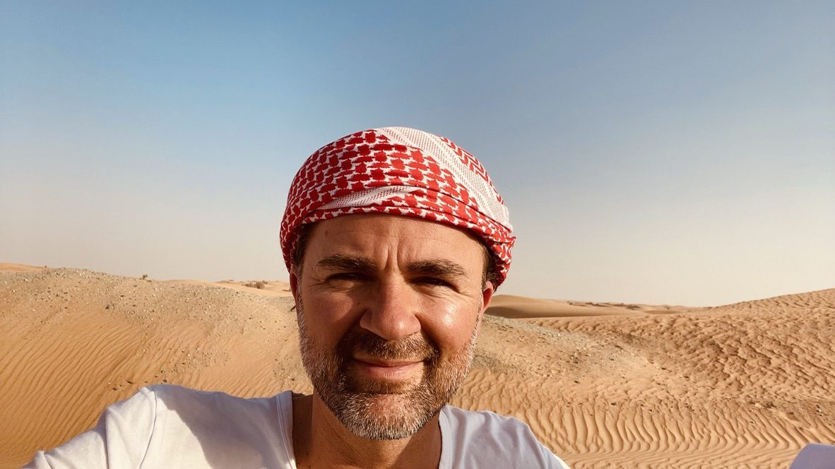 Local guide wearing a shemagh in the dunes