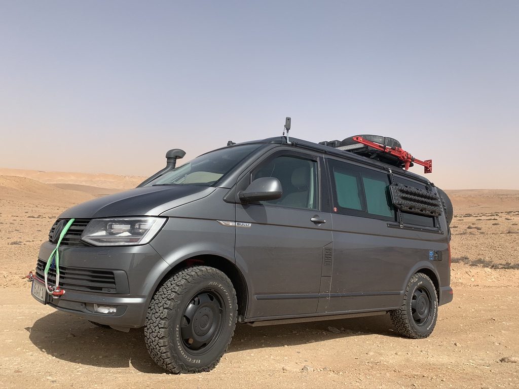 Expedition vehicle standing in open desert